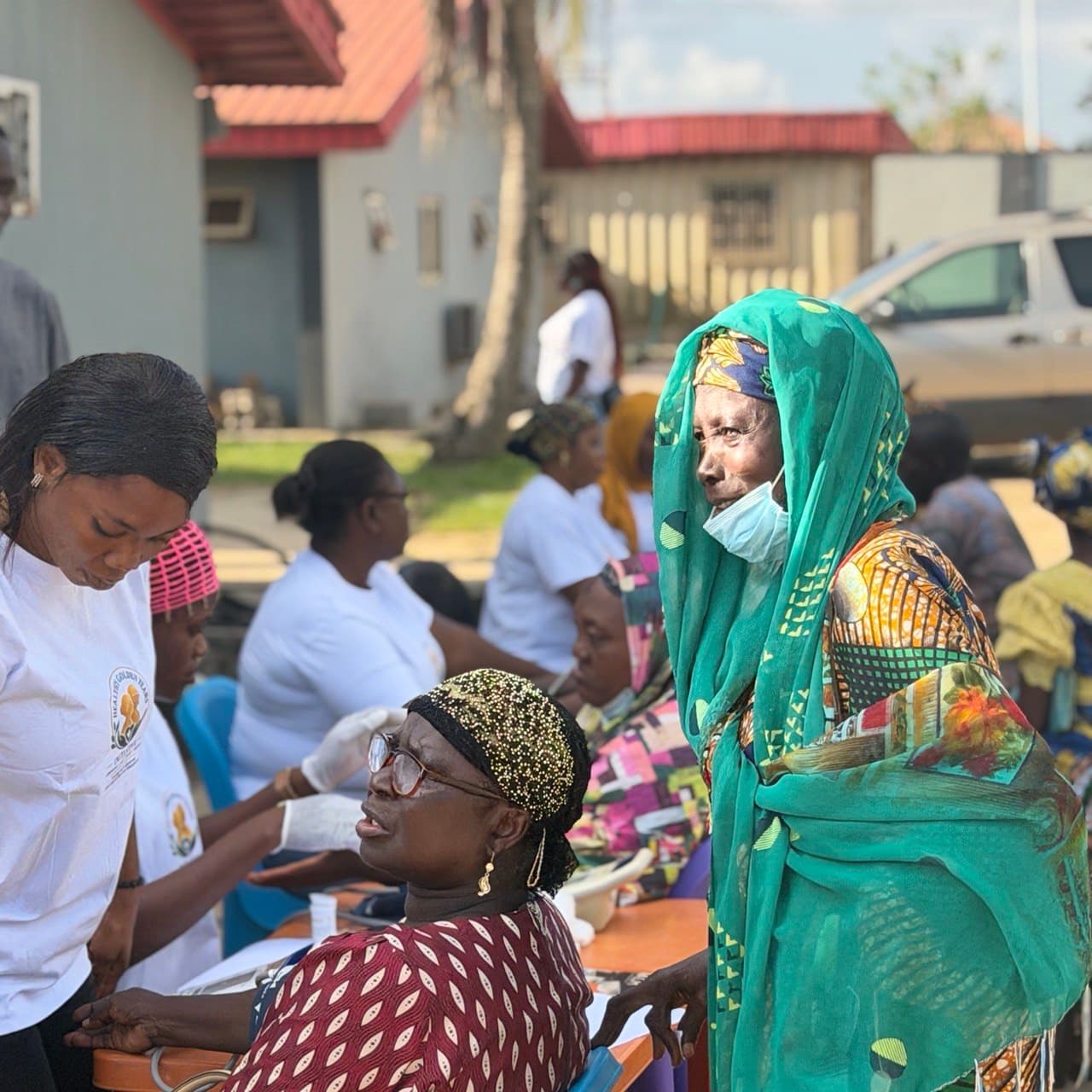 Healthcare professionals engaging with villagers during a rural community outreach