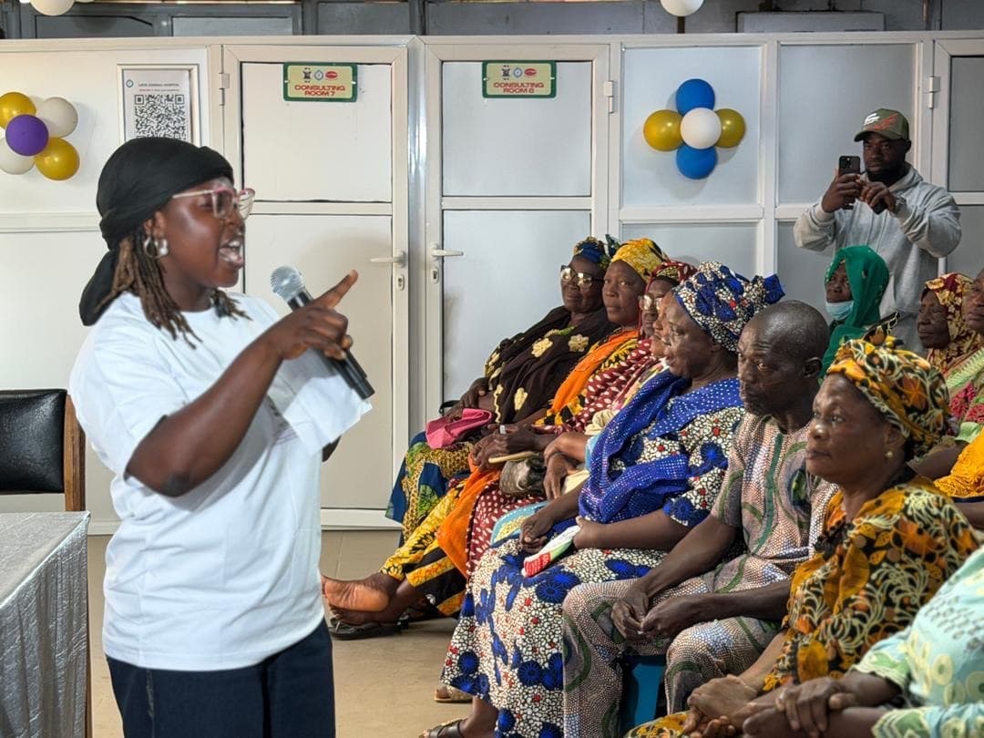 A healthcare worker leading a health education session with older adults